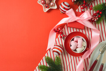 Merry Christmas and New Year background with bow, gift box, marshmallow and decorations. Top view, flat lay