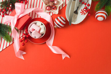 Merry Christmas and New Year background with bow, gift box, marshmallow and decorations. Top view, flat lay