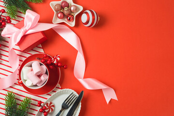 Merry Christmas and New Year background with bow, gift box, marshmallow and decorations. Top view, flat lay