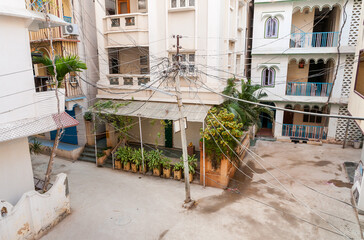 Street view with an electric pole positioned in the center of the road in Puttaparthi, Andhra Pradesh, India