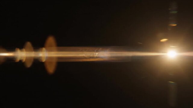 Jittery motion shakes the lens flare overlay against black background vibration