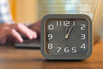 Office desk clock and working hands background