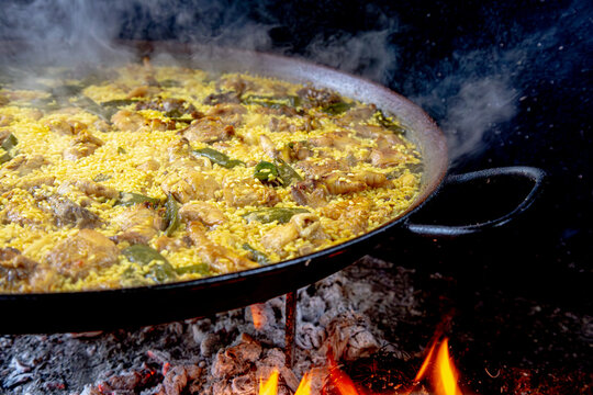 Traditional Valencian paella cooking process: resting phase to allow the rice to settle &ndash; Mediterranean cuisine in Spain.