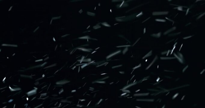 A dense field of snow fragments whipping rapidly through frame. Designed as a cinematic Christmas VFX plate for winter storytelling, dramatic overlays, and seasonal motion graphics.