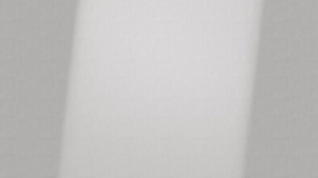 Soft Moving Light Across Minimal Textured Wall Background