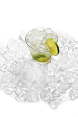 Classic lime caipirinha with sugar, muddled lime, and cachaça on a bed of ice against a white background.