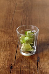 Preparing the classic lime caipirinha, also called saquerinha, on a wooden table.