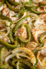 Sheet pan chicken fajitas with sliced onions, green bell peppers, and seasoned chicken arranged on a baking tray. Fresh, simple, and perfect for meal prep or easy dinner recipes.