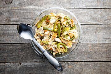 Sheet pan chicken fajitas with sliced onions, green bell peppers, and seasoned chicken arranged on a baking tray. Fresh, simple, and perfect for meal prep or easy dinner recipes.