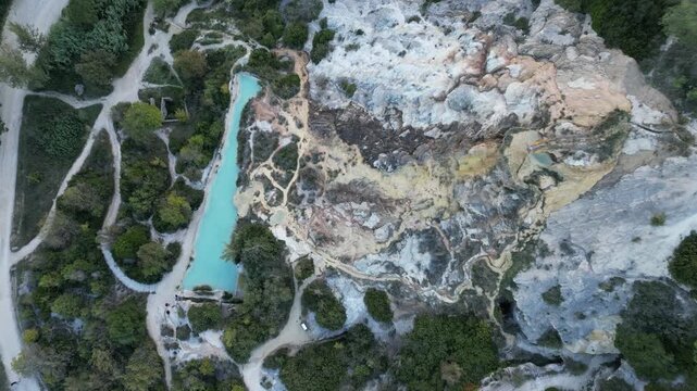 Aerial drone footage of the Antiche Terme Romane Libere, showcasing ancient Roman thermal ruins, natural pools, and the surrounding landscape. Captured from above with cinematic movement and clear arc