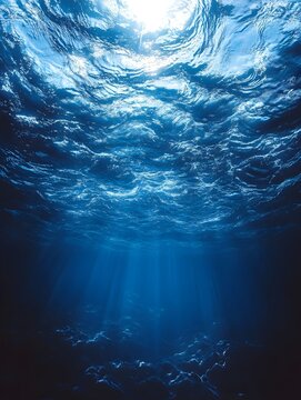 A serene underwater scene showcasing vibrant blue hues and soft sunlight filtering through the water, creating a peaceful and calming ocean atmosphere.