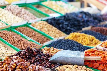 Dried fruits and nuts with scoop at the Osh Bazaar market in Bishkek, Kyrgyzstan, Central Asia