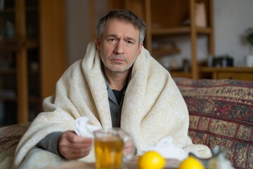 Ill Man Wrapped In Blanket At Home