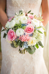Pink and White Wedding Bouquet Held by Bride in Lace Dress
