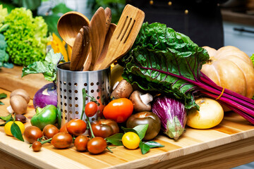 Pumpkin slices with broccoli, herbs and green vegetables arranged on wooden table creating healthy food composition for plant based cooking, autumn recipe ideas and kitchen inspiration