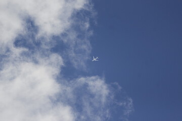 Boeing 747 Flying Over Cloudy Blue Sky – Iconic Airliner Travel Photography