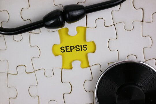 a yellow puzzle piece labeled 'SEPSIS' fitting into a white jigsaw, complemented by a stethoscope. Symbolizes medical awareness, diagnosis, and the connection between healthcare and sepsis management.