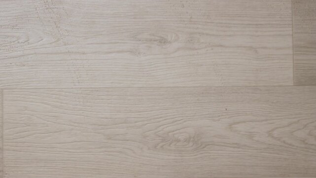 Cleaning a wooden floor with mop top view