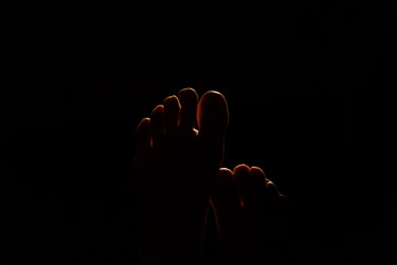 Crossed Feet in Intense Backlighting