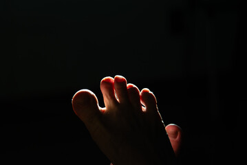 Crossed Feet in Intense Backlighting