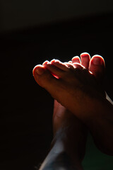 Crossed Feet in Intense Backlighting