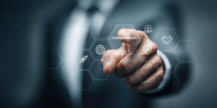 Business competences and skills development concept. Businessman pointing at virtual interface with icons representing teamwork, leadership, innovation, and goal achievement. Corporate training, emplo