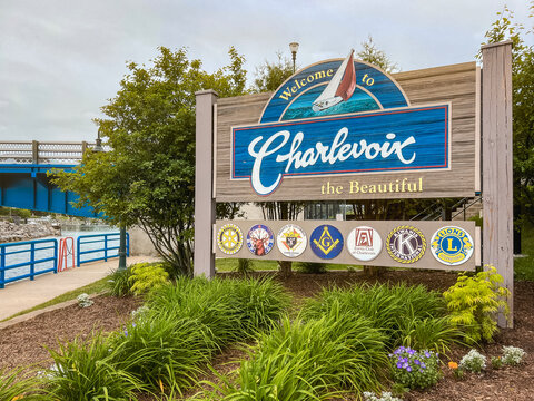 Charlevoix, Michigan, USA, June 24, 2025 : Colorful wooden sign welcomes visitors to the beautiful town of Charlevoix. Charming and vibrant city in the Northern part of the state on Lake Michigan.