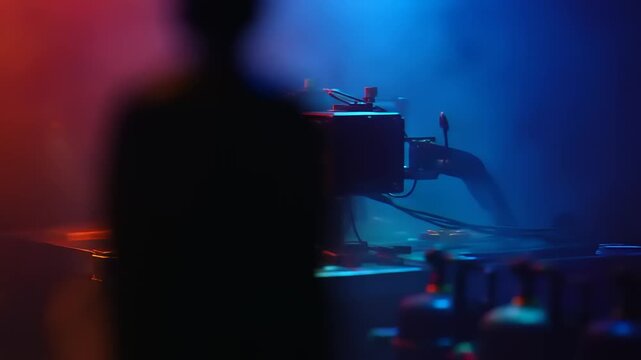 DJ setup in a club with colorful lights and smoke effects.