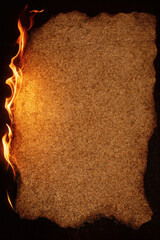 Aged parchment engulfed in flames, a dramatic canvas of texture and light. Burned edges frame an earthy expanse, ready for inscription.