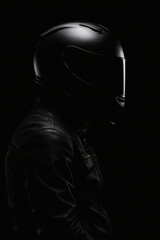 A figure in shadow, wearing a protective helmet and a leather jacket, embodying mystery and safety in monochrome. Ready for the open road.