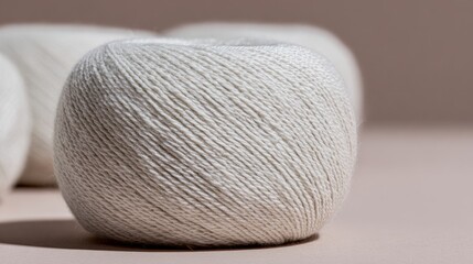 Photorealistic macro photo of beige wool yarn balls in minimalistic setting, showcasing texture and detail, perfect for crafting and textile design inspiration