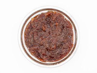 Top view of textured indian lemon pickle in a round glass bowl