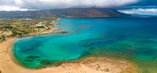 Obraz premium Aerials of Trachilos and Viglia Beach and storm clouds over Geroskínos, Crete, Greece