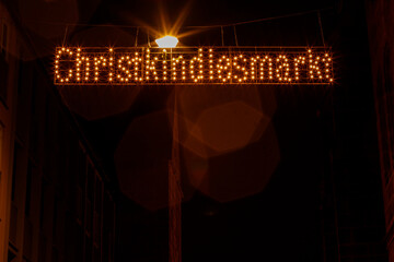 Nuremberg Christkindlesmarkt sign illuminating German Christmas market at night