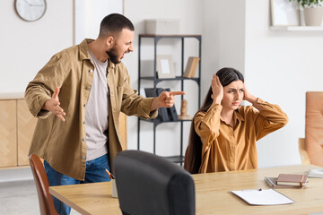 Young man screaming at his wife in psychologist's office
