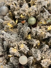 Snow-Covered Christmas Tree with Ornaments and Lights