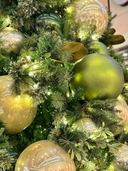 Close-Up of Christmas Tree with Green and Gold Ornaments