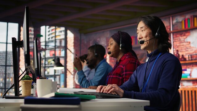 Call center admin team working together to provide live chat support, handling clients complaints. Teamworking colleagues in office dealing with unsatisfied customers, providing solutions, camera B