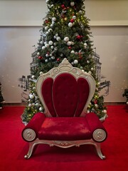 Red Velvet Chair with Christmas Tree Backdrop