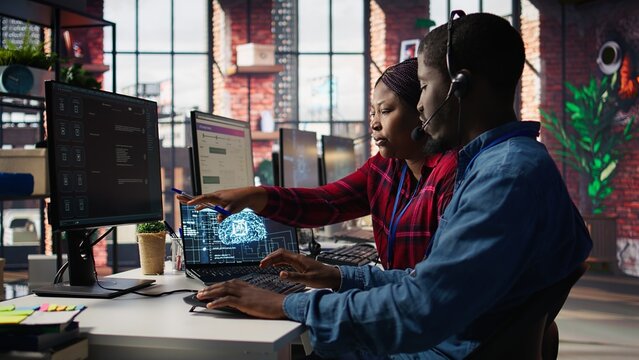 Call center manager teaching intern how to use AI to enhance customer interactions. Team leader in customer service office explaining trainee how to use artificial intelligence, camera B - Powered by Adobe