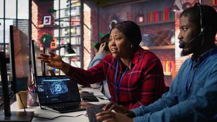 Call center coworkers brainstorming how to answer customers, using AI chatbot. Team of agents doing...