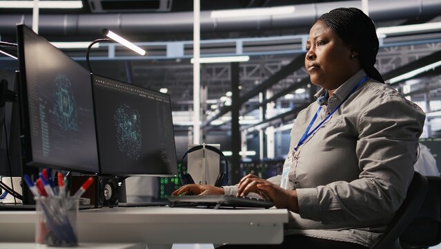 Data center computer scientist using PC to monitor artificial intelligence visualization. Server farm IT professional overseeing rigs powering machine learning processes, camera A - Powered by Adobe