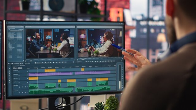Video editors team working with AI chatbot and montage maker software, editing a background video and mixing clips on dual monitors. Professional man and woman in creative process. Camera B.
