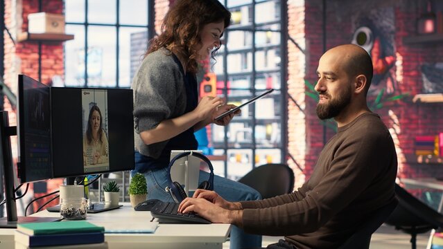 Social media video creators at agency office use editing tools and artificial intelligence to produce high quality reels aimed at improving engagement, monetization and reach. Camera B. - Powered by Adobe