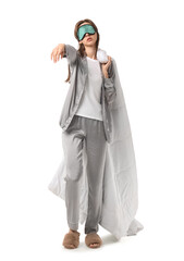 Female sleepwalker in pajamas with blanket on white background