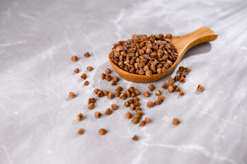 Close up of Buckwheat Grains in Bamboo Spoon
