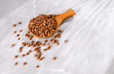 Close up of Buckwheat Grains in Bamboo Spoon