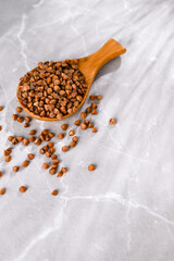 Close up of Buckwheat Grains in Bamboo Spoon