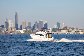 Motor yacht cruising on Hudson Bay with a panoramic view of Brooklyn skyline