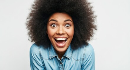 Woman with afro hairstyle smiling broadly with enthusiastic expressive energy